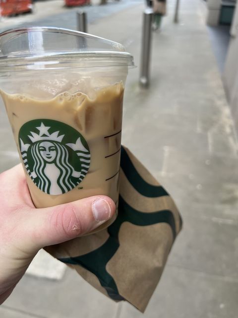 Photo of me holding an iced latte