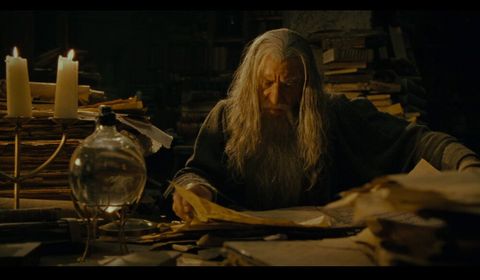 Gandalf browsing through papers in the library of Minas Tirith.